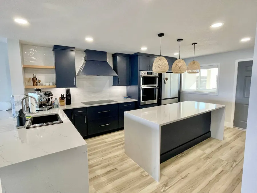 Navy kitchen with newly installed white quartz countertops