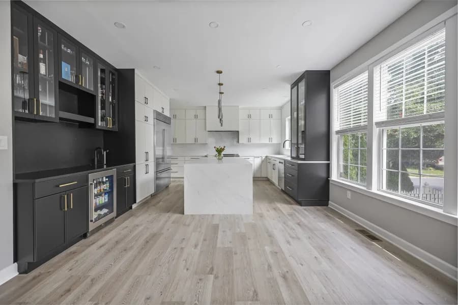 Contemporary kitchen with full-height dark cabinetry and a marble island