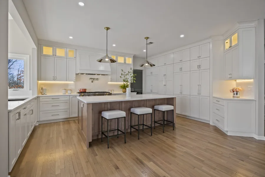 Kitchen with white perimeter cabinets and a wood island