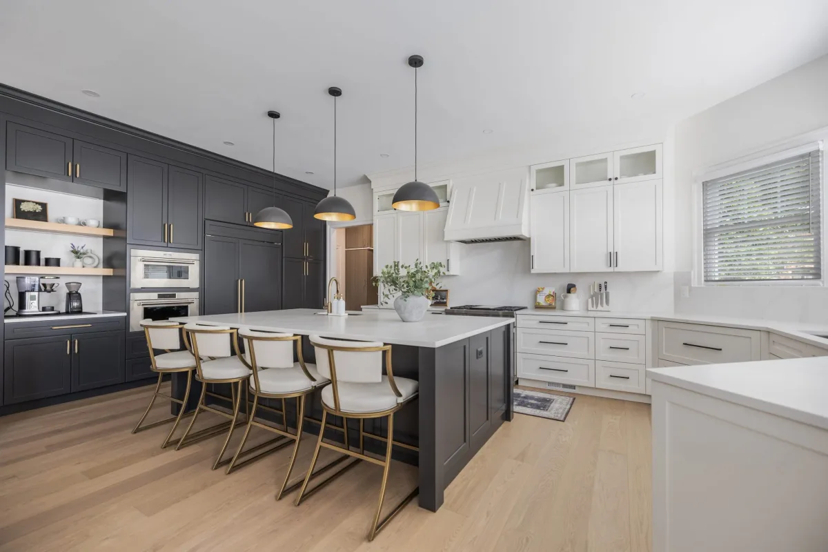Finished kitchen with black and white cabinetry and an island with seating